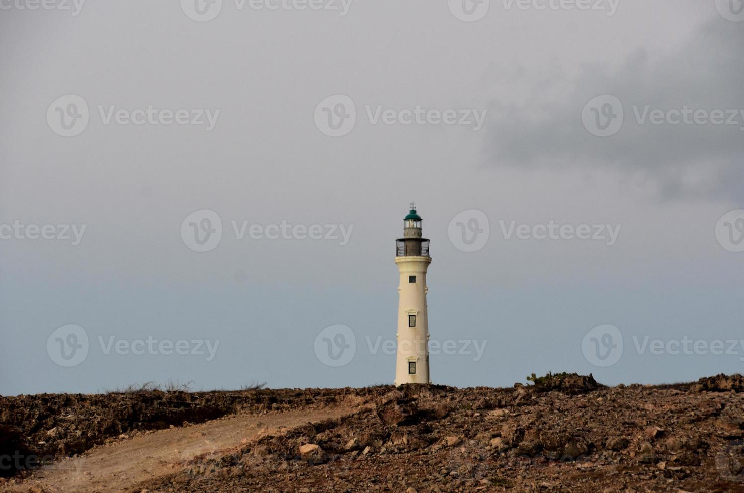 California Lighthouse at Sunrise with Rugged Landscape photo