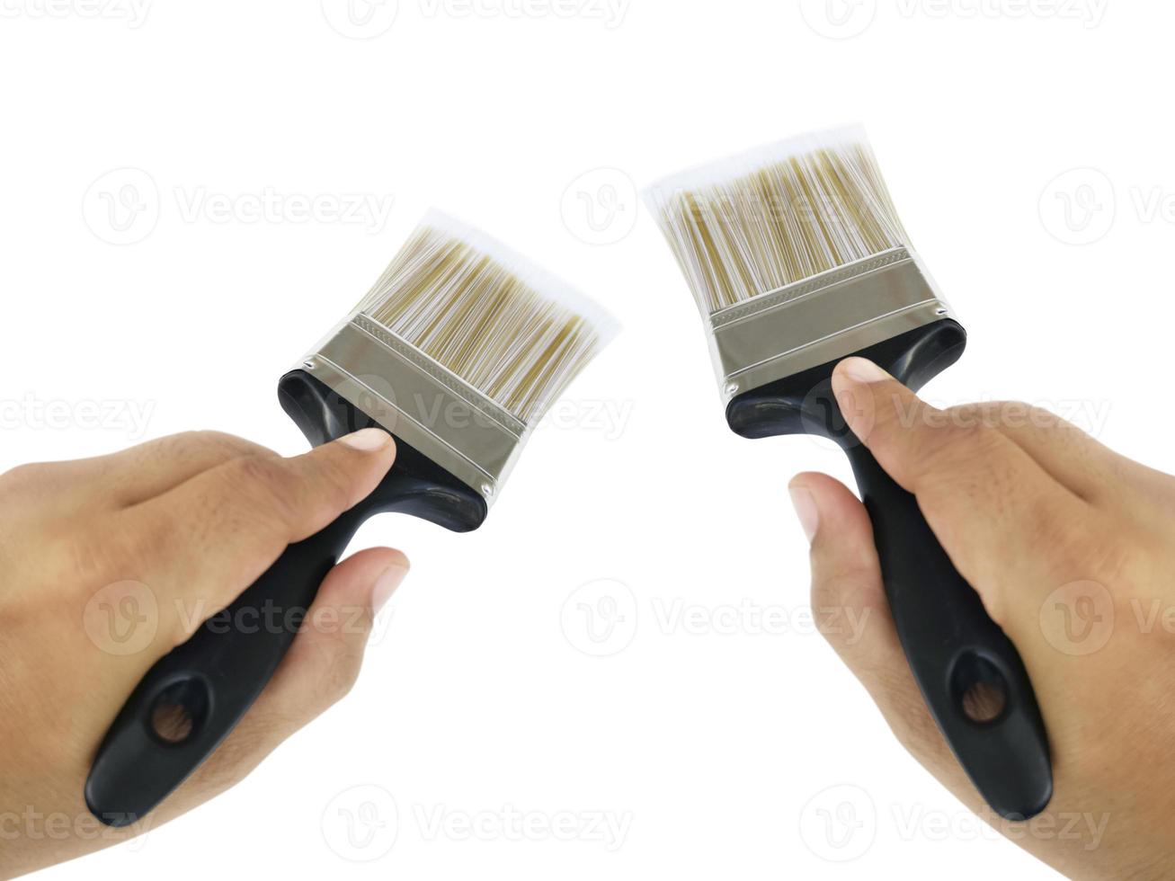 hand holding Paintbrush isolated on white background photo