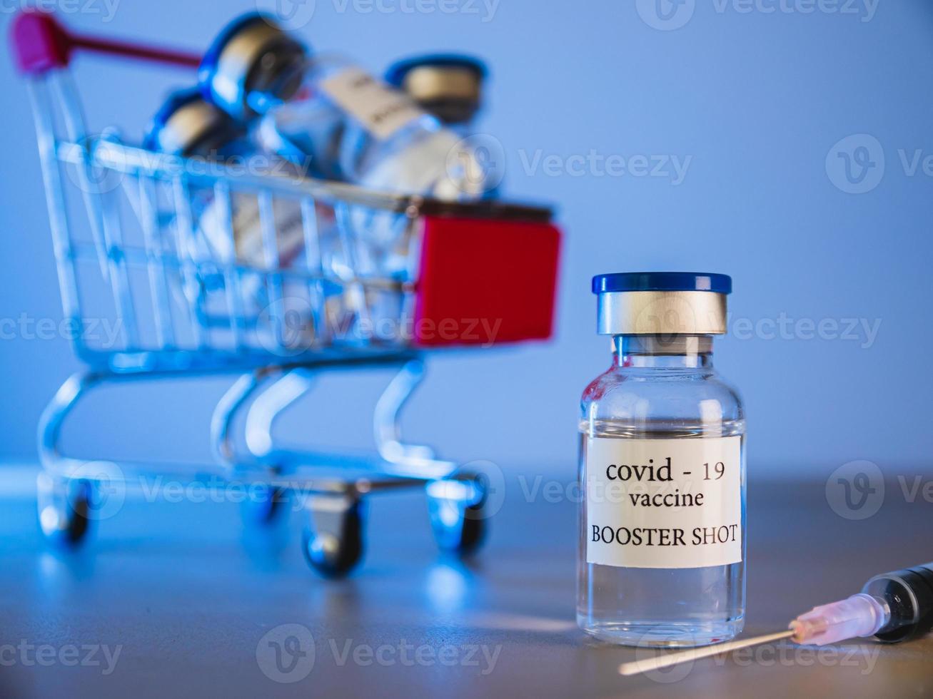 COVID-19 booster vaccine vials in shopping cart. Medicine and health care concept photo