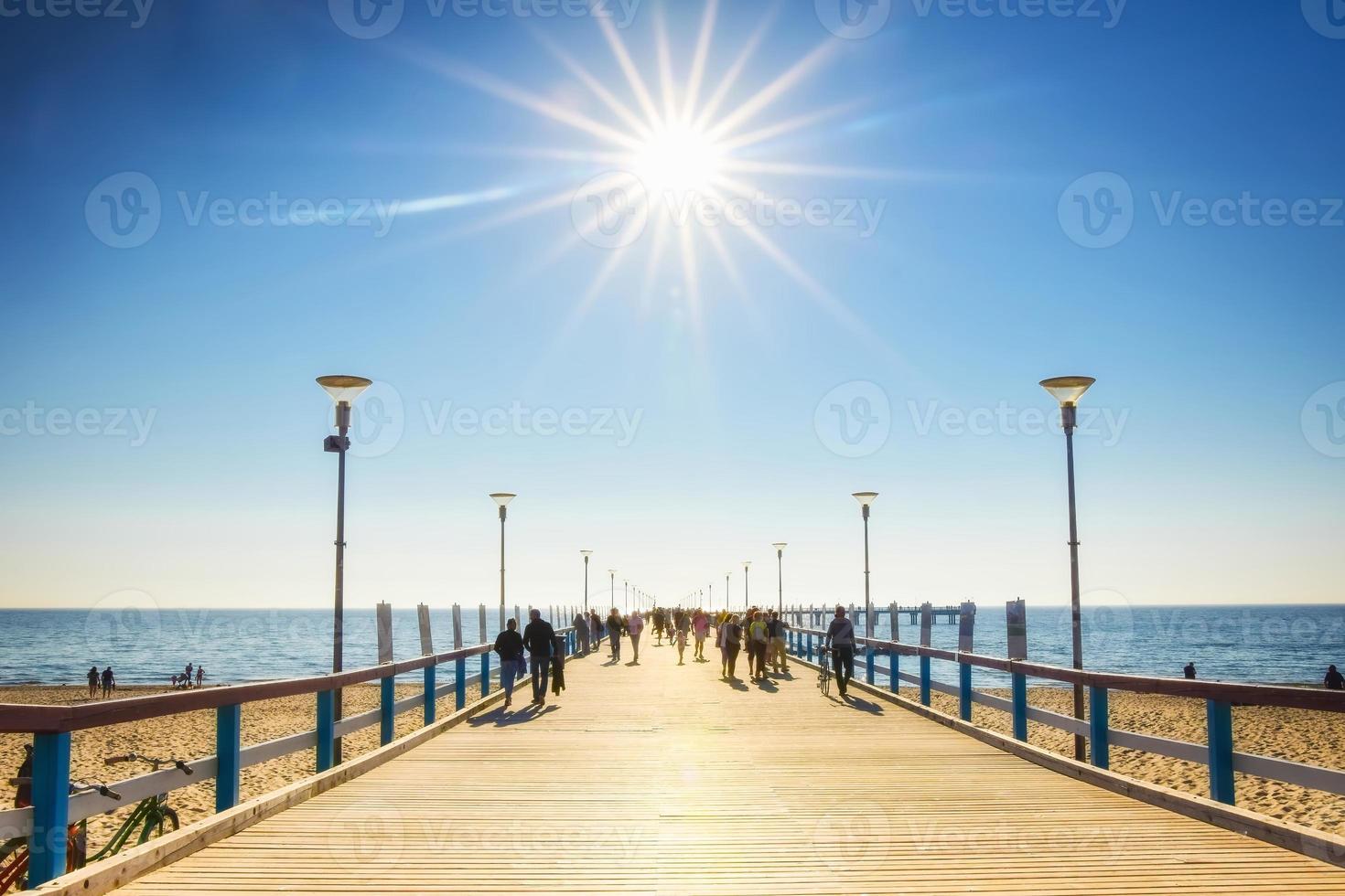 Palanga, Lithuania, 2021 - Palanga pier with tourists walking in heat in sunny summer day. Lithuania holiday destination photo