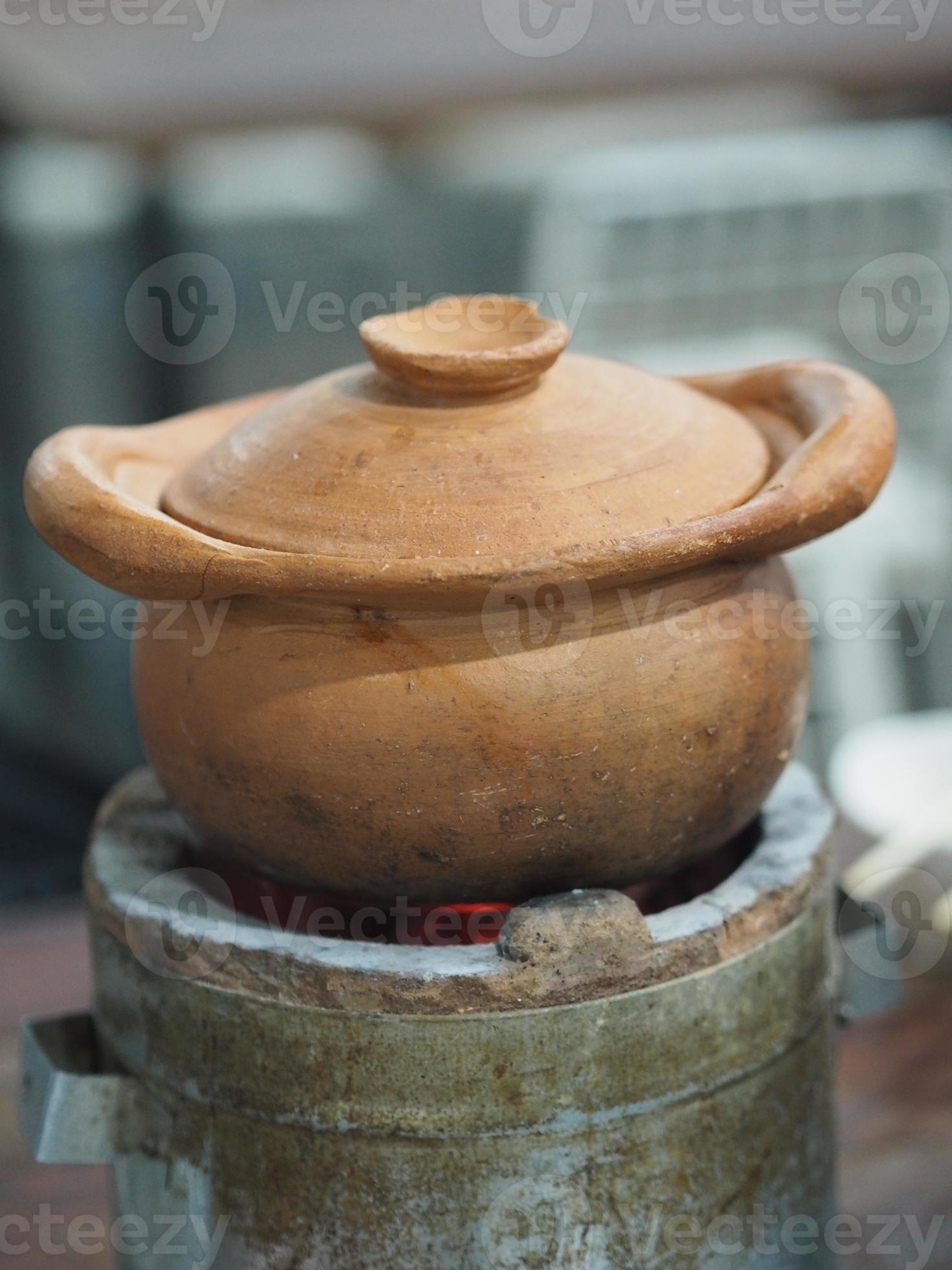 Hot pot Clay pot on charcoal stove 9105931 Stock Photo at Vecteezy
