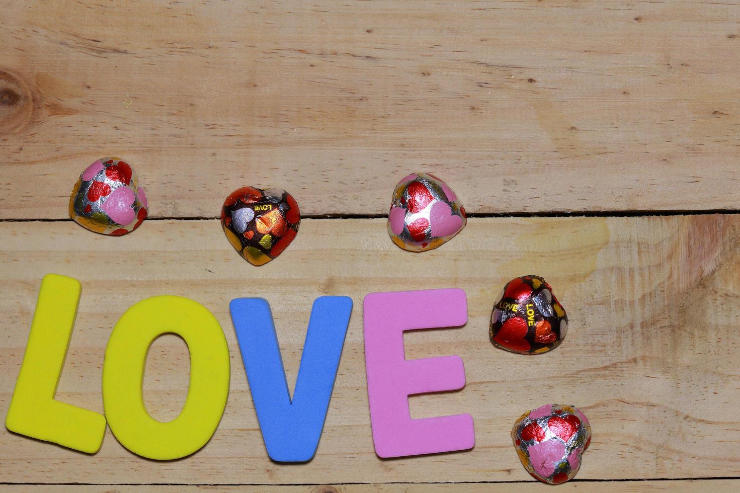 Love letters and Chocolate heart on the wooden floor. Background Valentine's Day with hearts. valentine concept. Space for text. photo