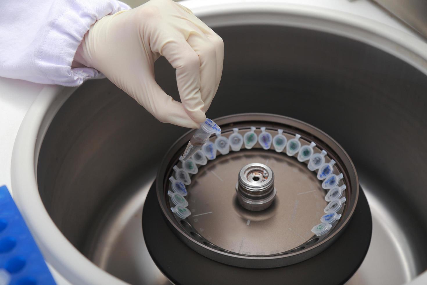 Scientist loading a sample to centrifuge 9112431 Stock Photo at Vecteezy