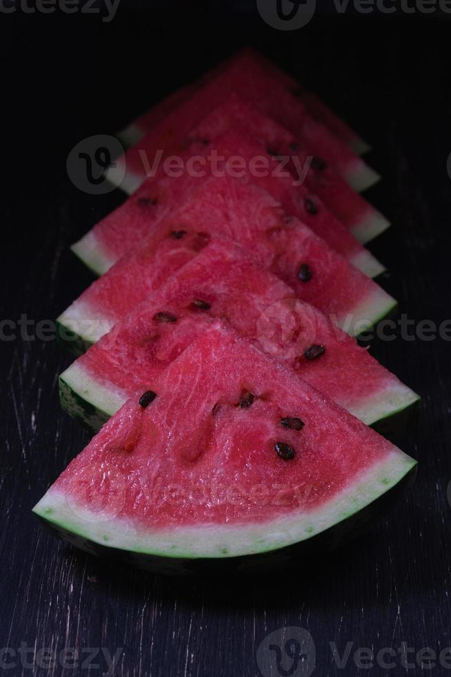 Pieces of refreshing watermelon on a dark wood background. Close-up photo. High quality photo