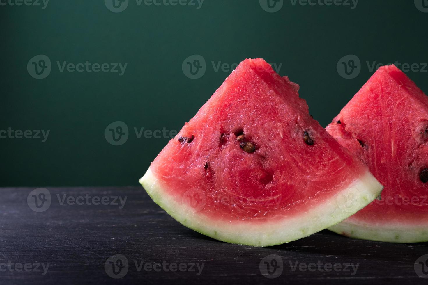Pieces of refreshing watermelon on a dark wood background. Close-up photo. High quality photo