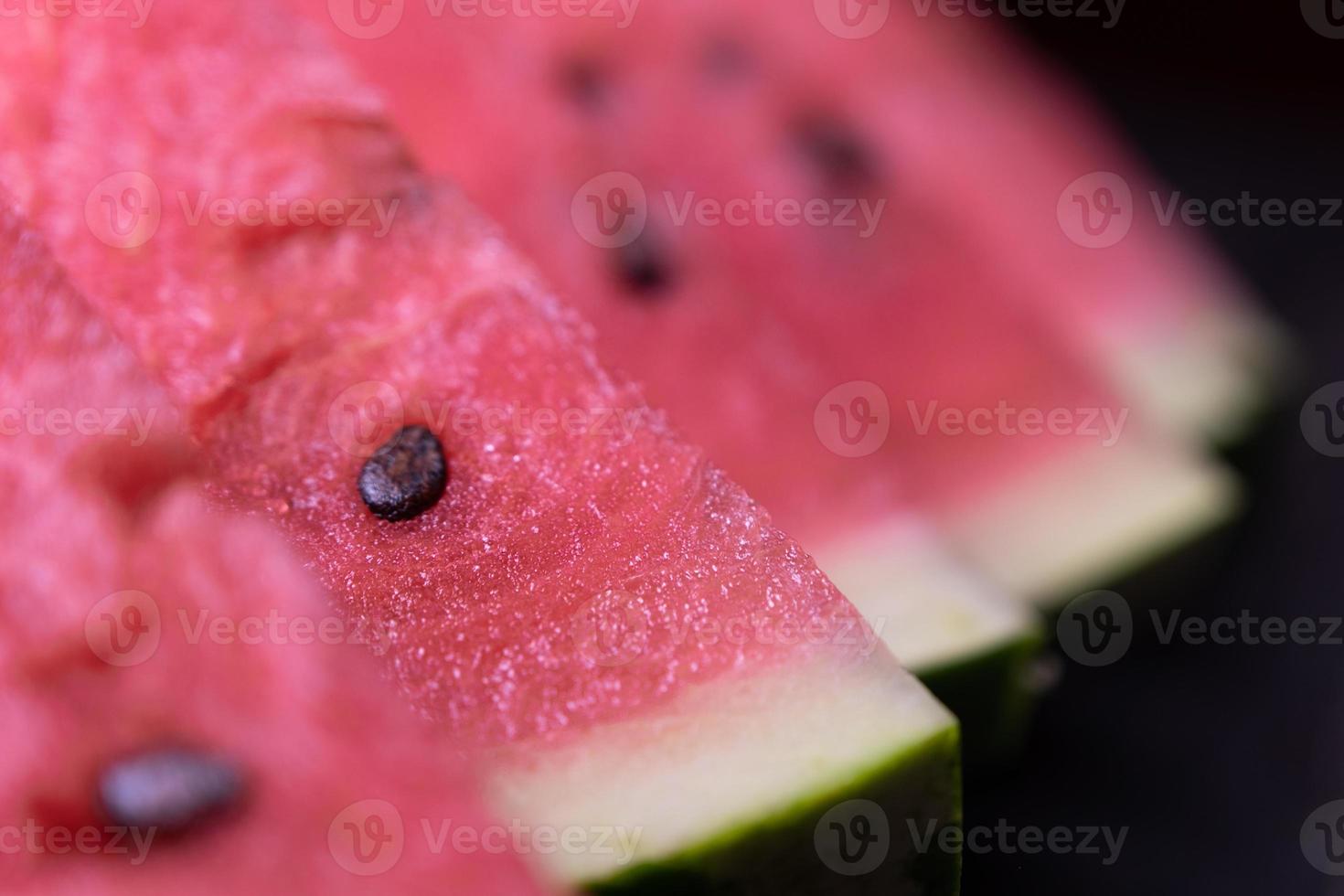 Pieces of refreshing watermelon on a dark wood background. Close-up photo. Fruit texture. Selective focus. High quality photo