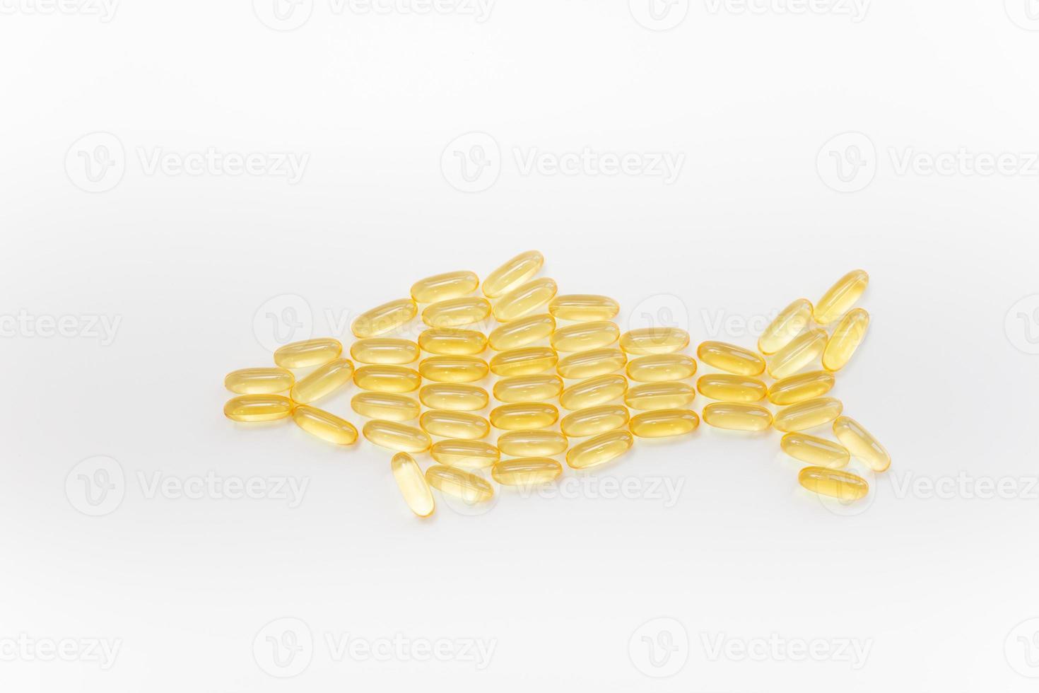 Fish shape Cod Liver Oil Capsules, Omega 3, Vitamin D on white background. Close-up, top view, copy space for your text. photo