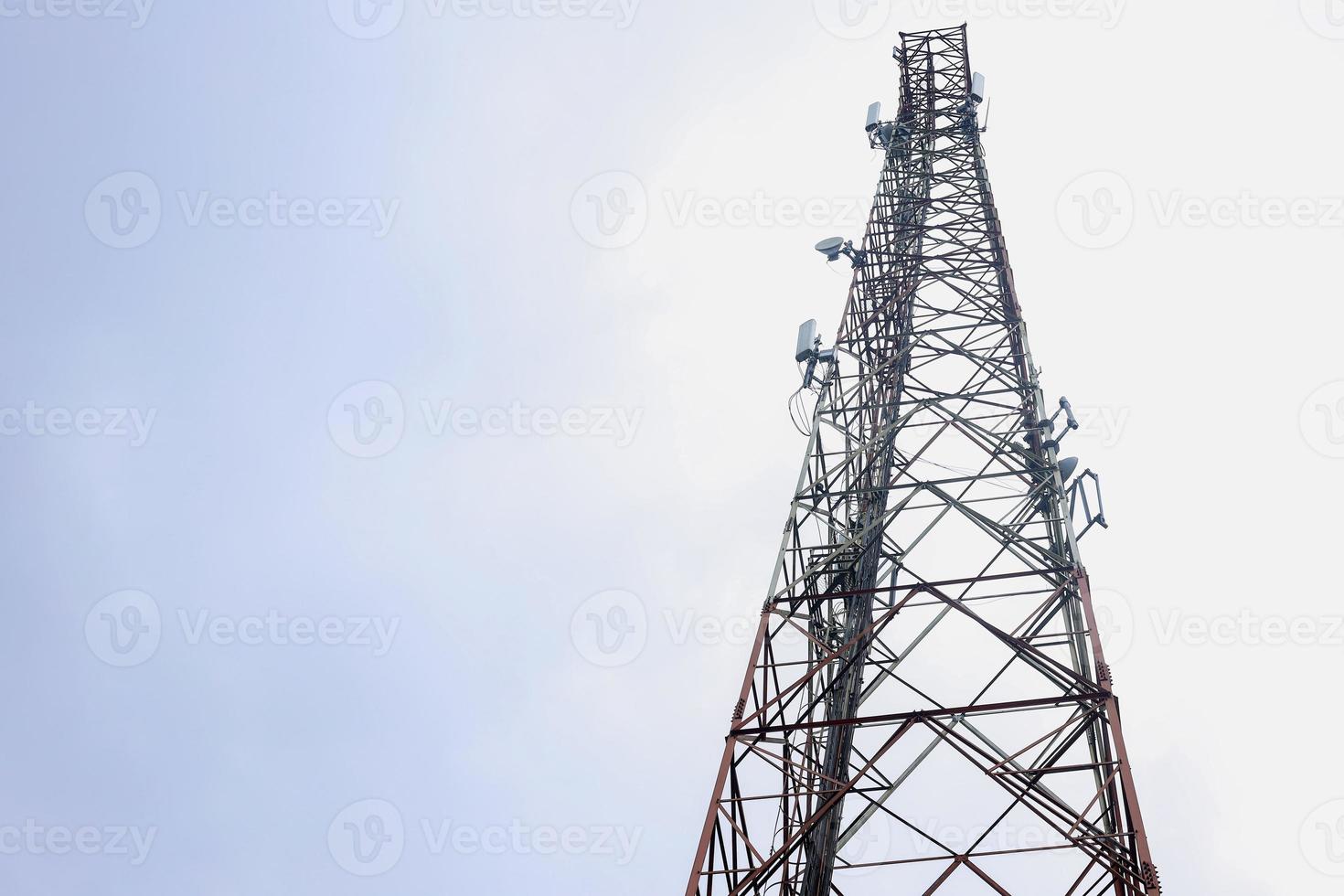 Satellite tower isolated on blue white cloud sky. Transmission Tower telephone and television signals. Radio communication tower. photo