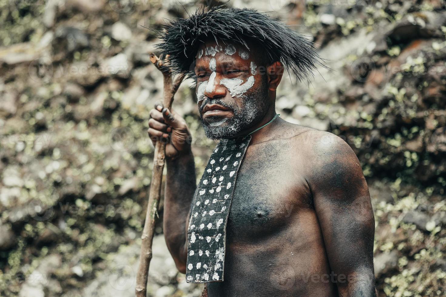 Close-up Papua man of Dani tribe against nature background. photo