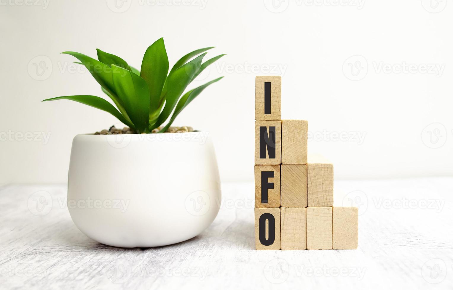 four wooden blocks with the letters info on the bright surface of a gray table photo