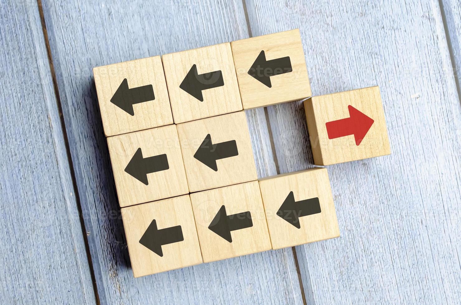 Wooden Block With Red Arrow Facing The Opposite Direction Black Arrow photo