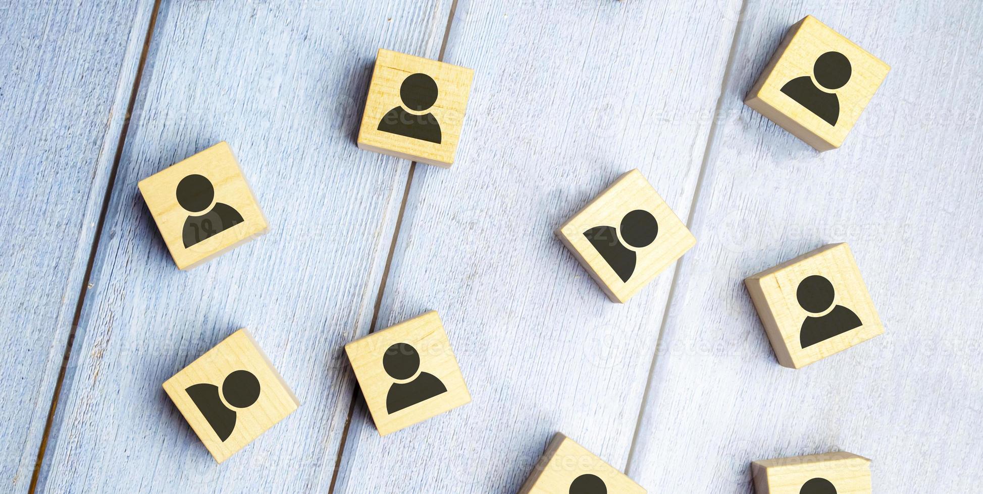 Head hunting and leadership concept. Wooden cube block with human icon symbol. photo