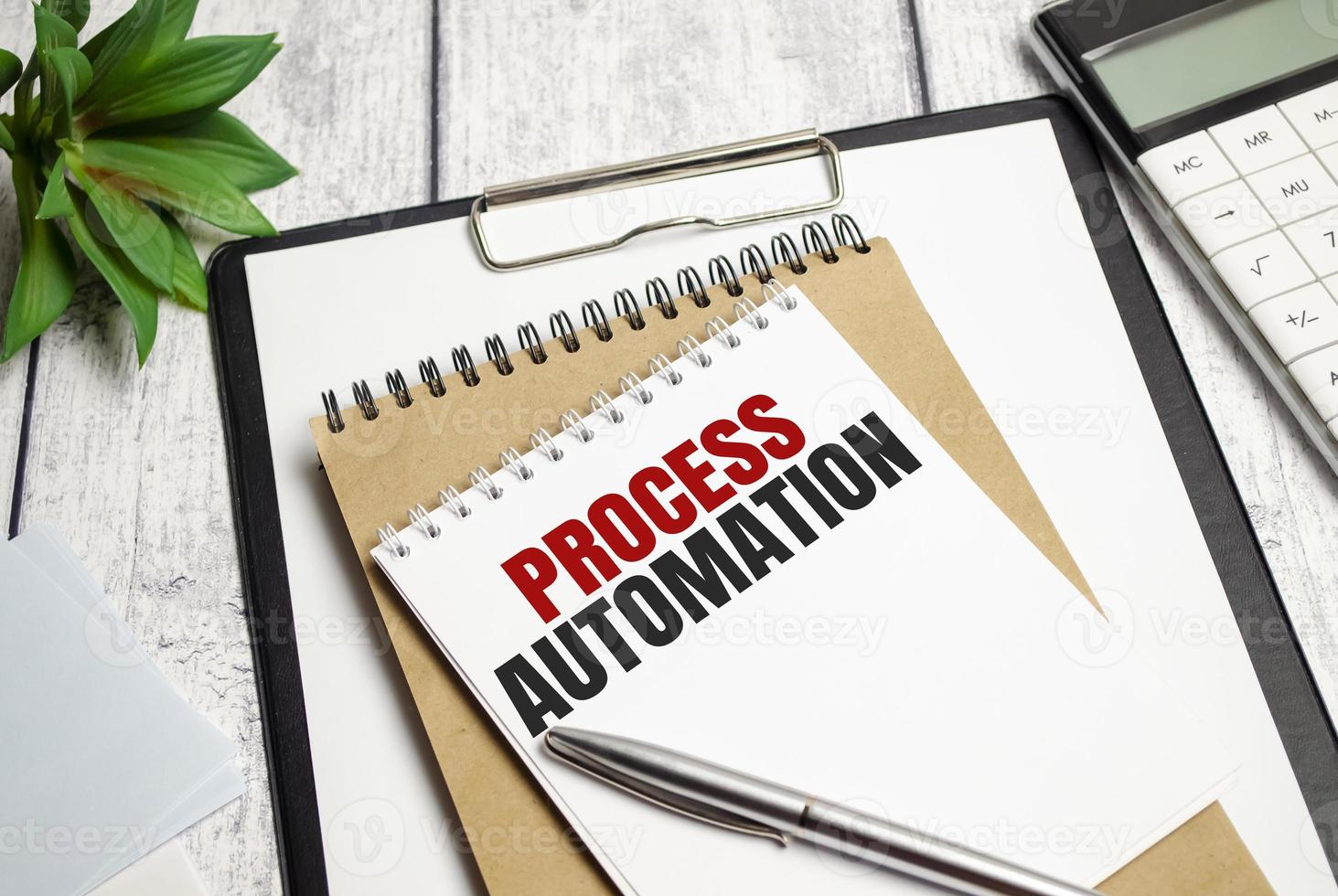 Text PROCESS AUTOMATION on Office desk on wooden background photo