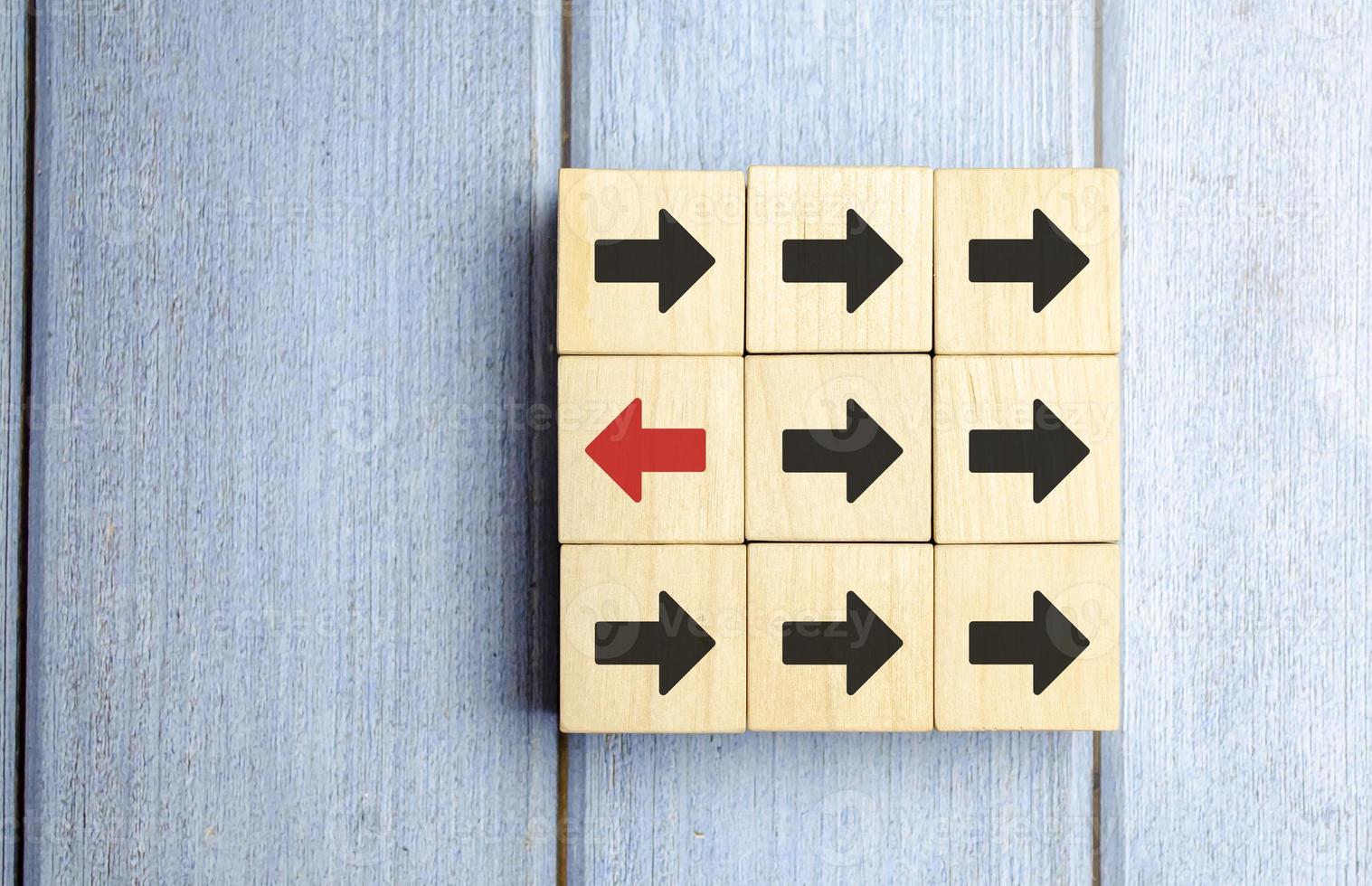 Wooden Block With Red Arrow Facing The Opposite Direction Black Arrow photo