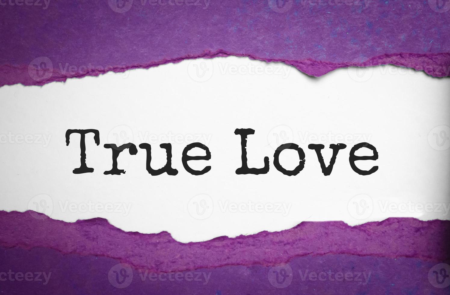 The text True Love appearing behind torn brown paper photo