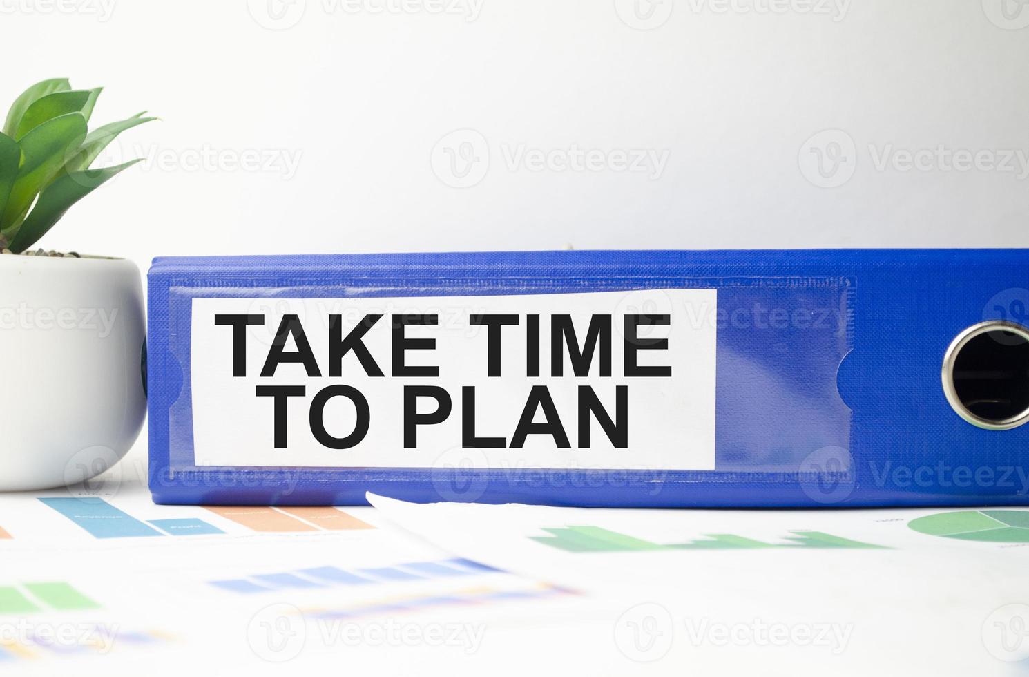 blue file folder with words take time to plan . Business concept photo