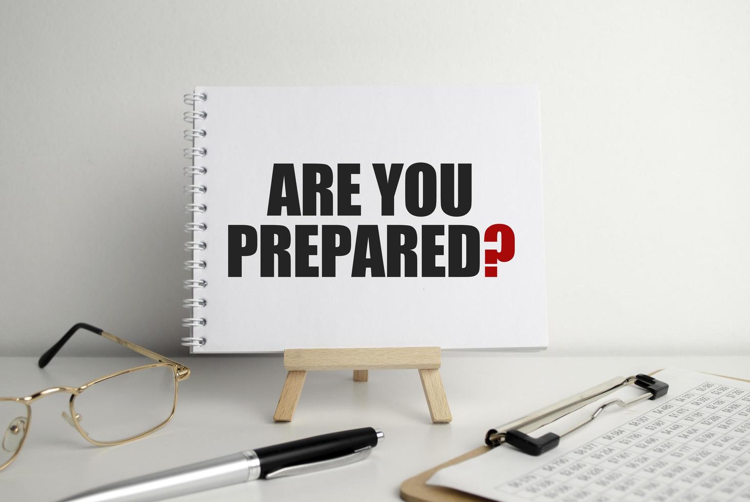 Are You Prepared Question, text on white paper on the light background with charts paper photo