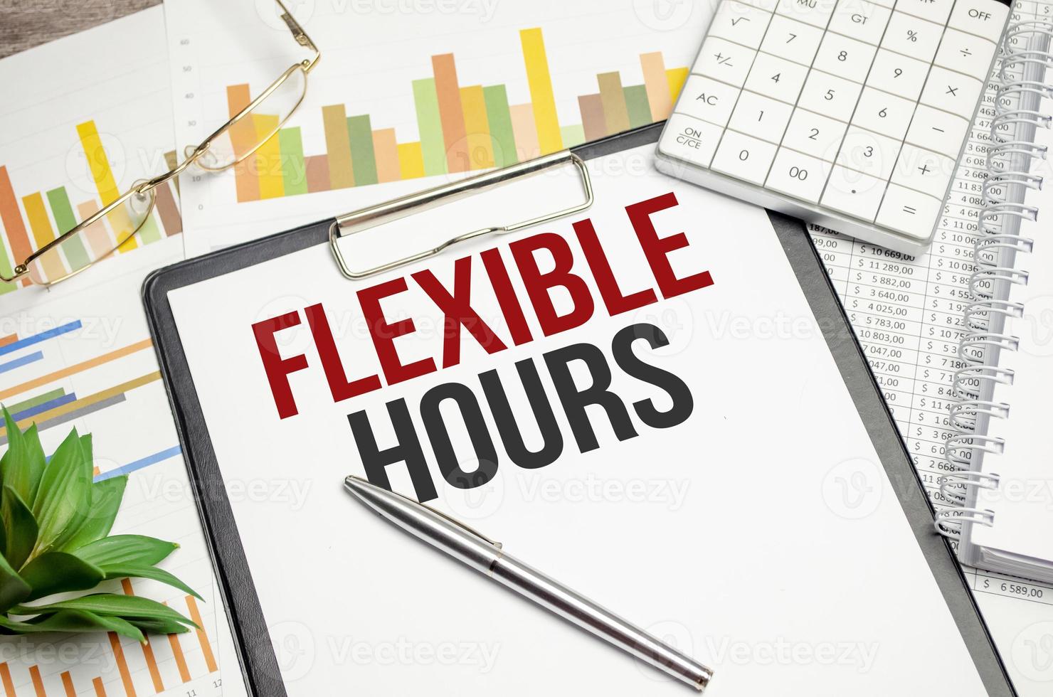 Paper with text FLEXIBLE HOURS on the table on the chart photo
