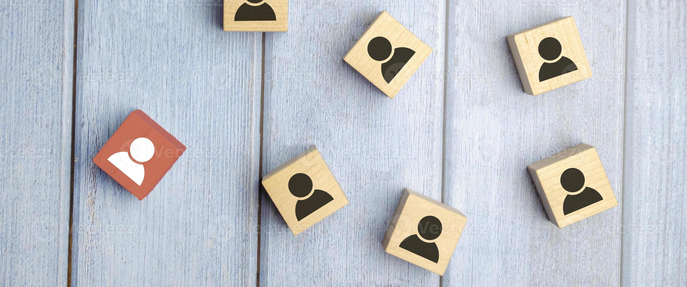 wooden cube blocks with printed blue human symbol. Leadership and team building concept photo