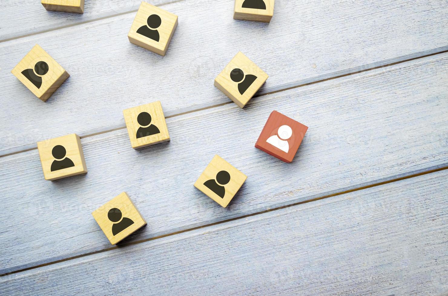 Head hunting and leadership concept. Wooden cube block with human icon symbol. photo