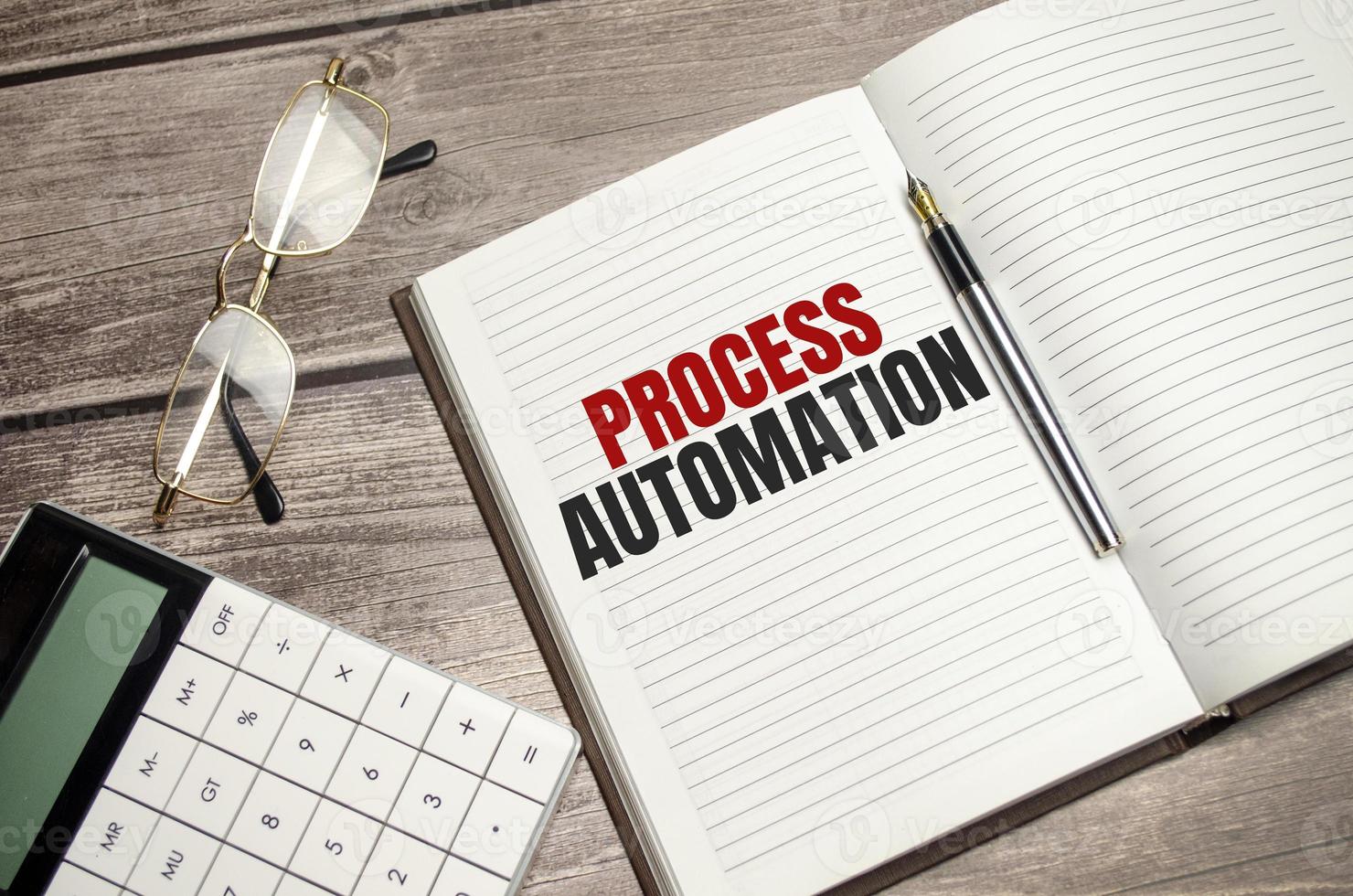 PROCESS AUTOMATION text on brown diary on wooden background photo