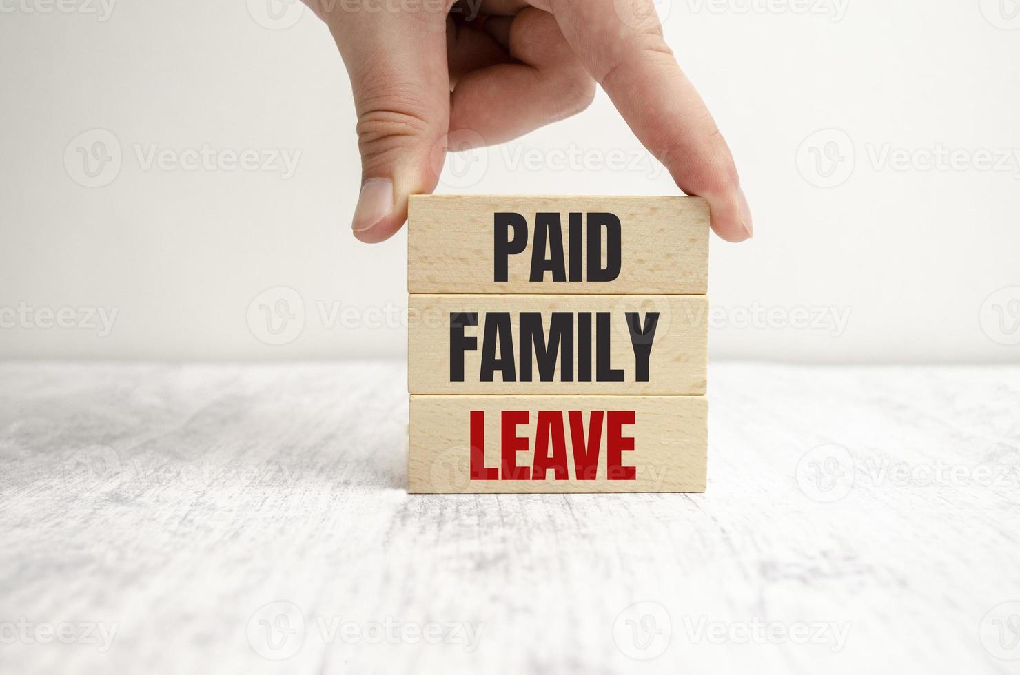 Paid family leave symbol. Concept words Paid family leave on wooden blocks. photo