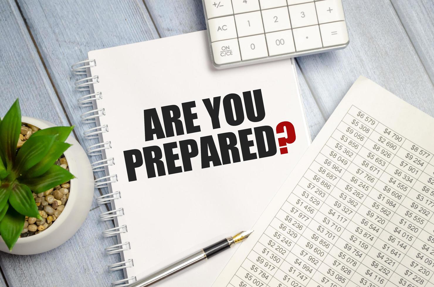 Text Are You Prepared Question on paper card and calculator on wooden background photo