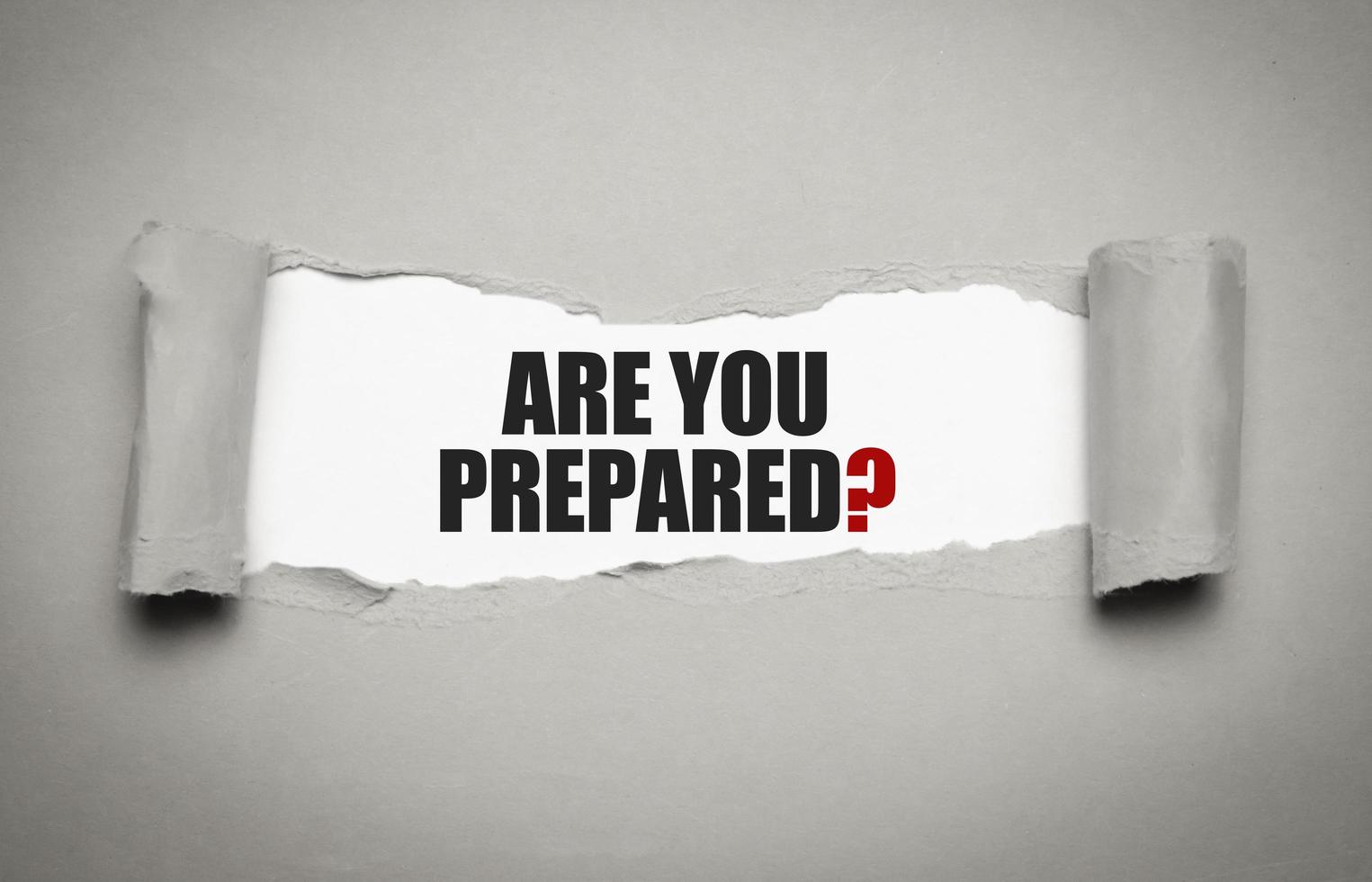 The text Are You Prepared Question appearing behind torn grey paper photo