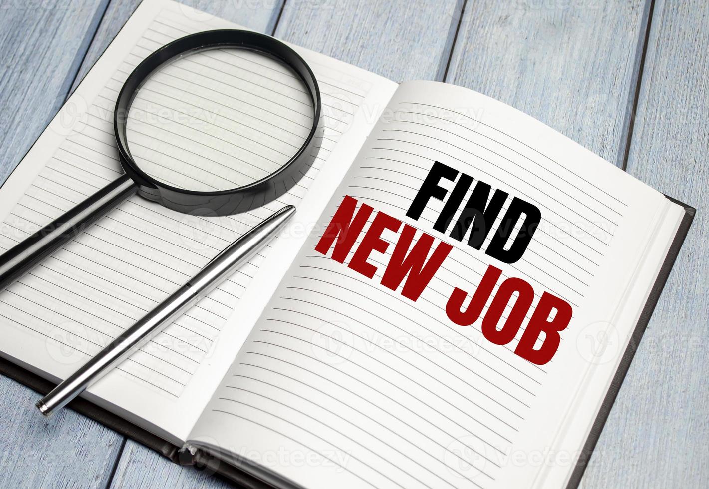 Find New Job . magnifier on brown notepad text on magnifier glass photo