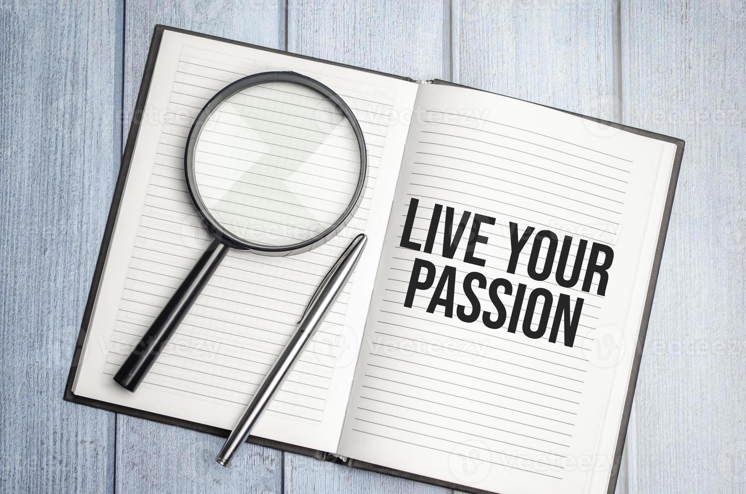 LIVE YOUR PASSION text on diary and magnifier photo