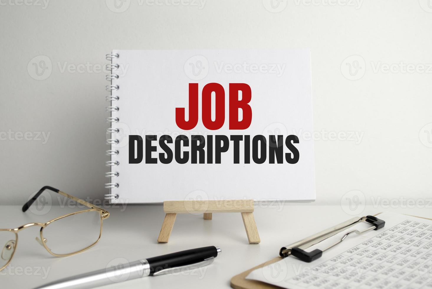 Text Job Descriptions typed on notepad and office supplies photo
