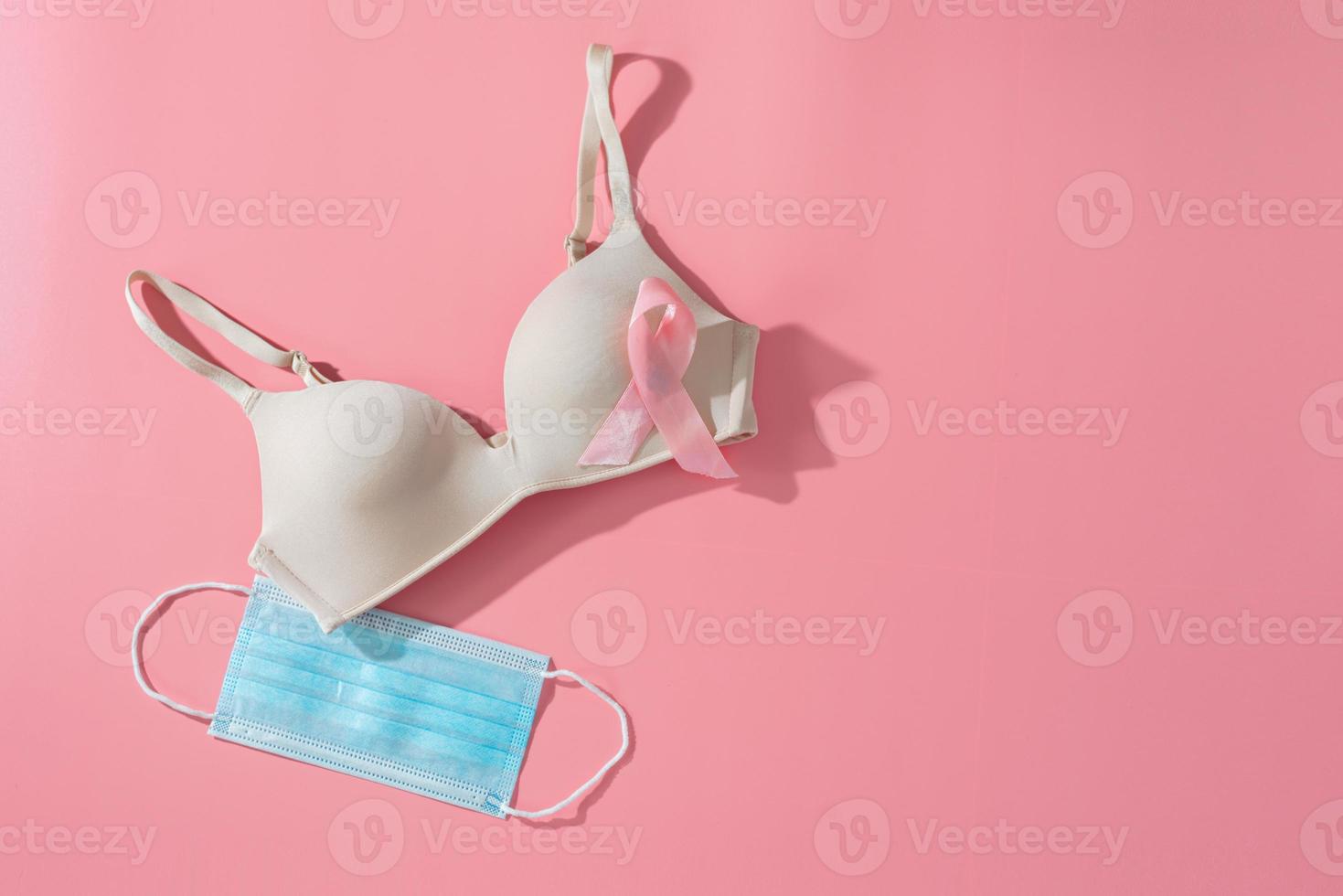 Bra with breast cancer awareness ribbon and hygienic mask. breast cancer coronavirus, Cancer awareness concept photo