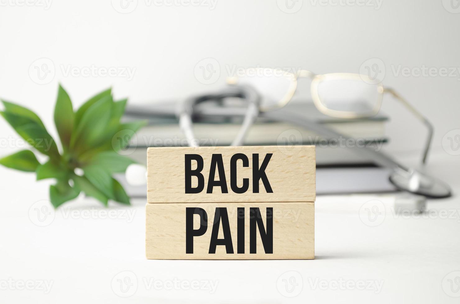 wooden blocks with words Back pain, beautiful white background photo