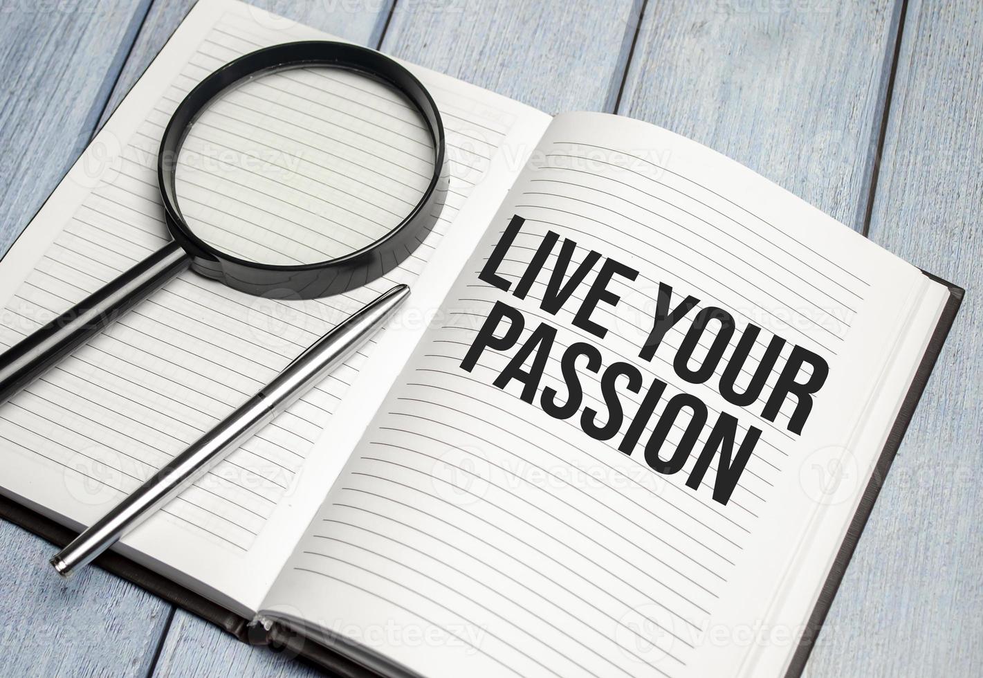 LIVE YOUR PASSION text on diary and magnifier photo