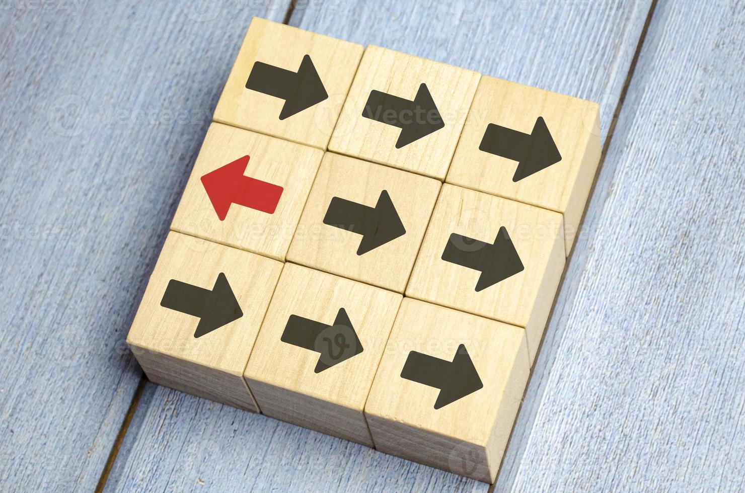 Wooden Block With Red Arrow Facing The Opposite Direction Black Arrow photo