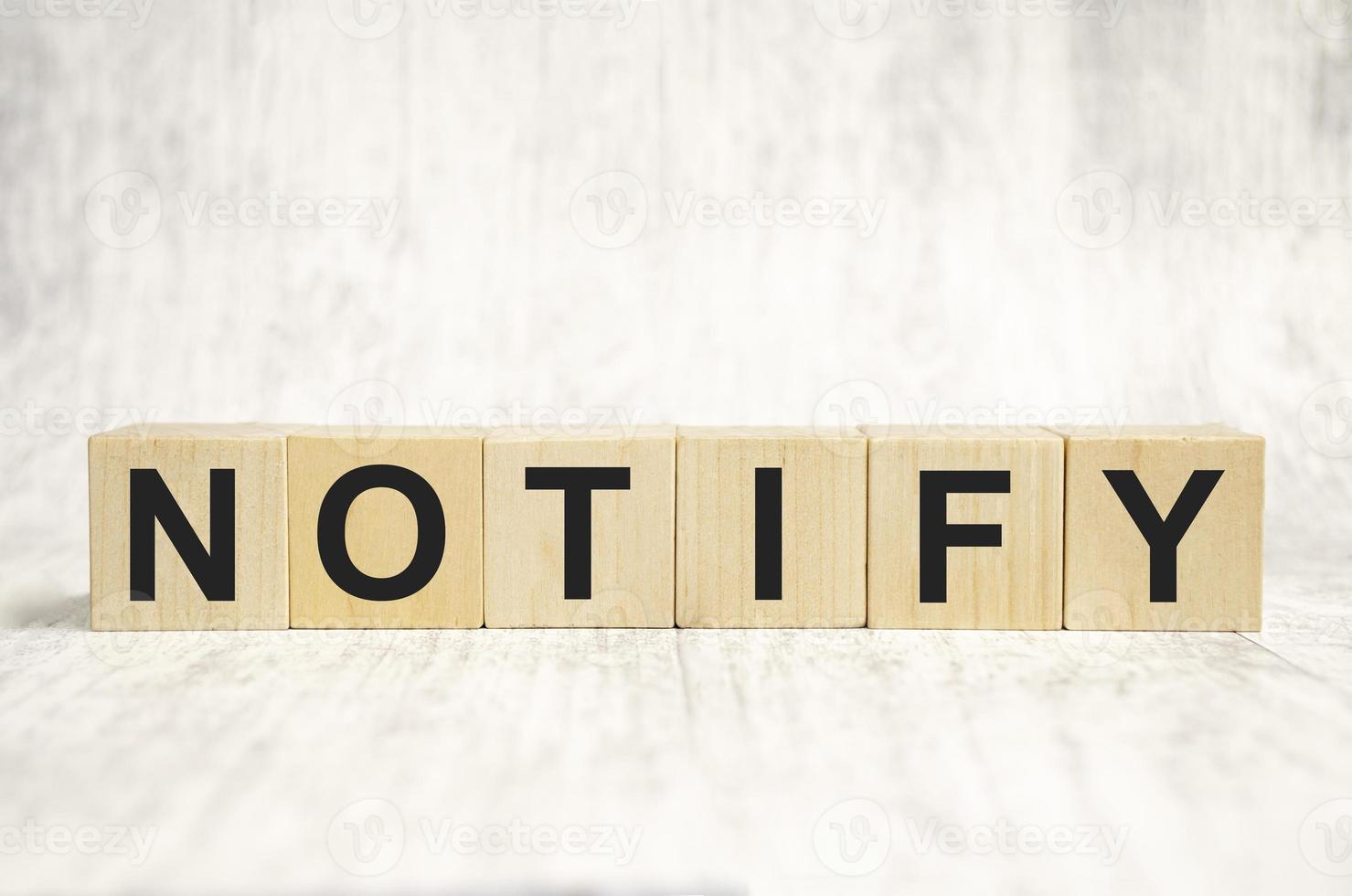 notify word made with wooden blocks. Business concept photo