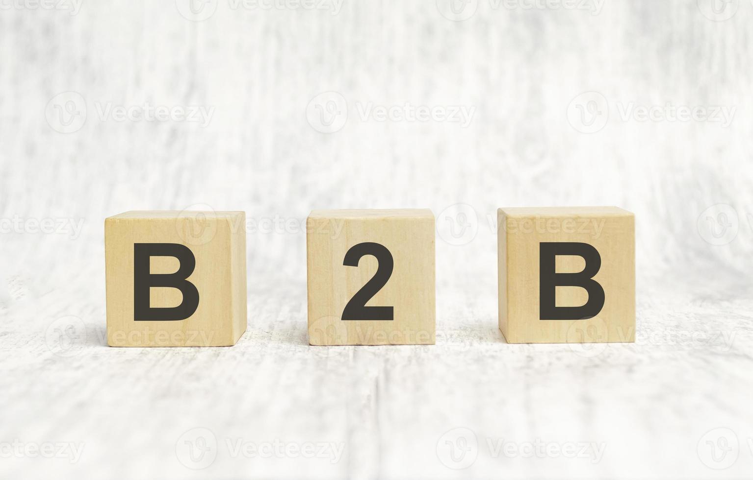 Text B2B - written on wooden cubes on wooden background photo