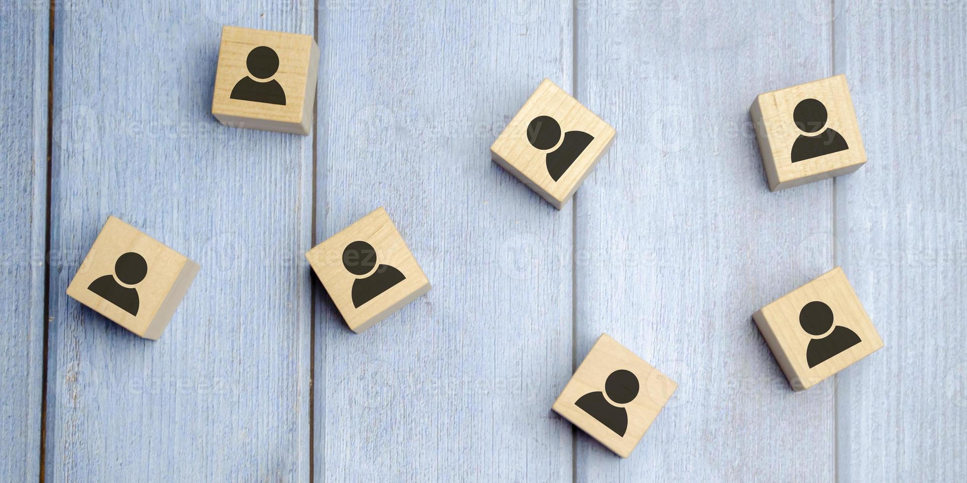 wooden cube blocks with printed blue human symbol. Leadership and team building concept photo