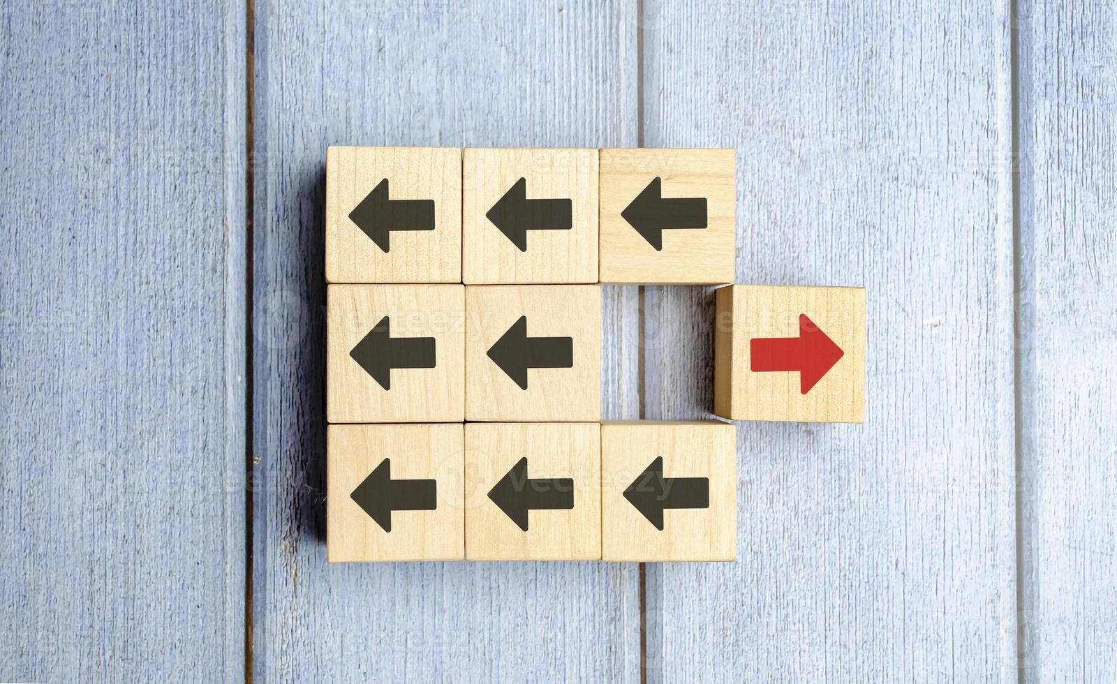Wooden Block With Red Arrow Facing The Opposite Direction Black Arrow photo