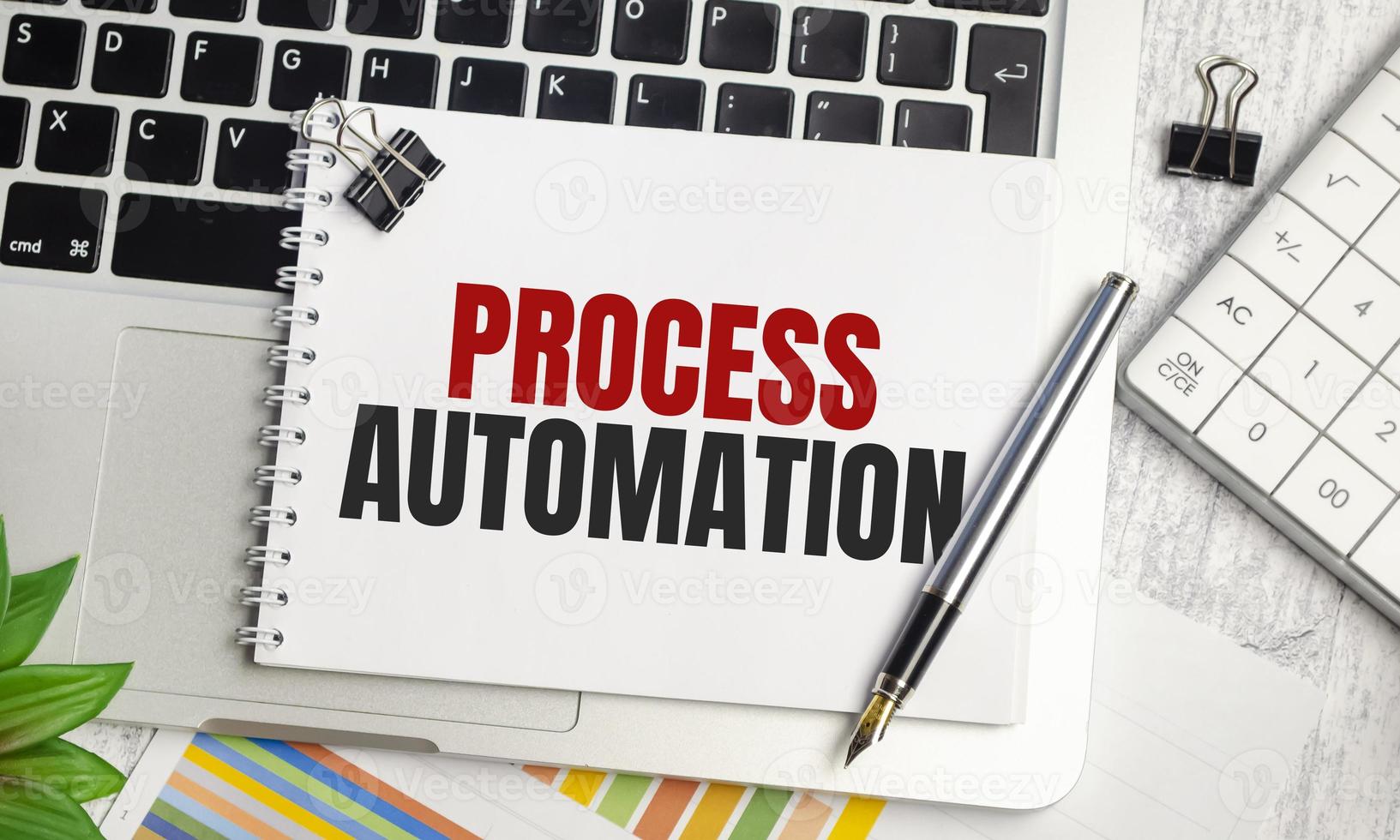 PROCESS AUTOMATION text on notepad and laptop, calculator and pen photo