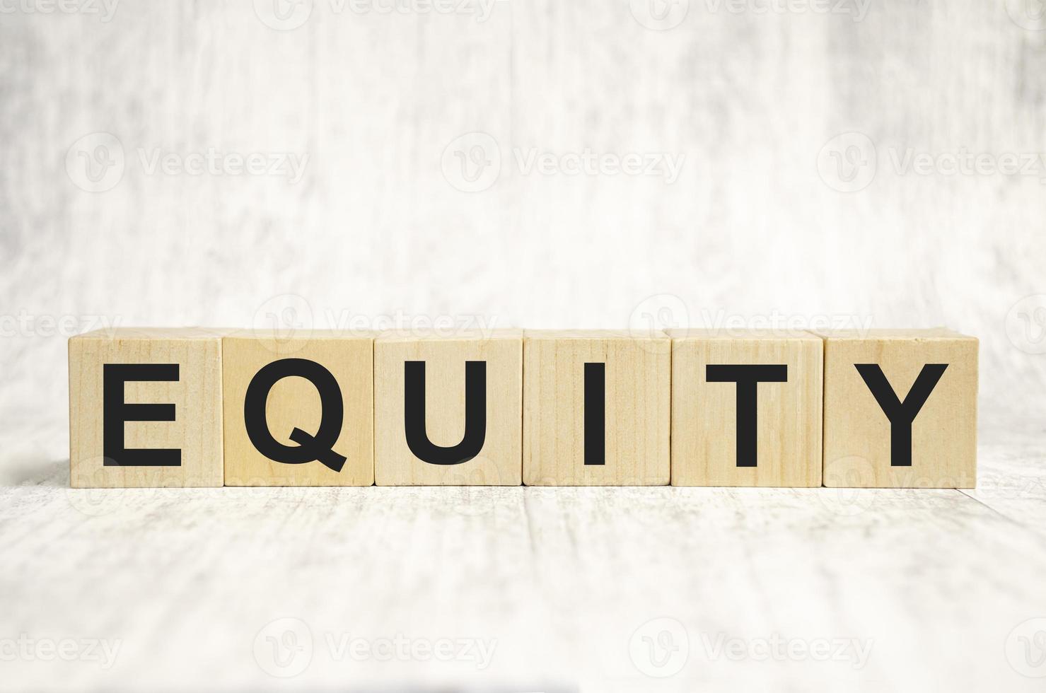 equity word background on wood blocks and white background photo