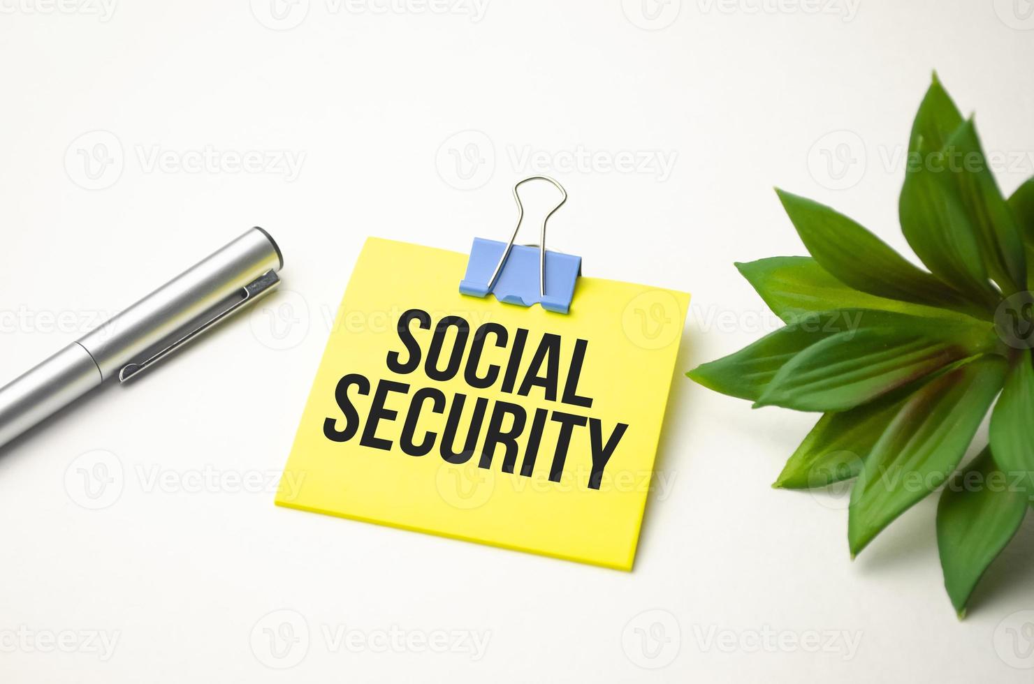 The text Social Security on yellow sticker and white background photo