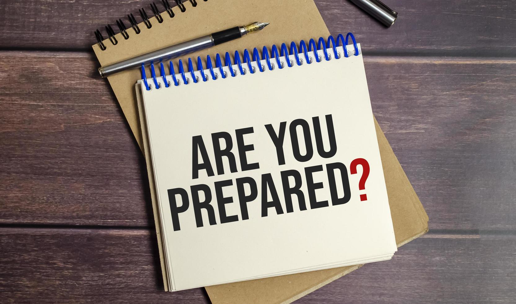 Are You Prepared Question words on notepad and wooden background photo