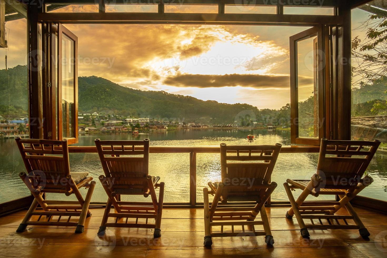 lake view at coffee shop in the morning sunrise, Ban Rak Thai village, landmark and popular for tourists attractions, Mae Hong Son province, Thailand. Travel concept photo