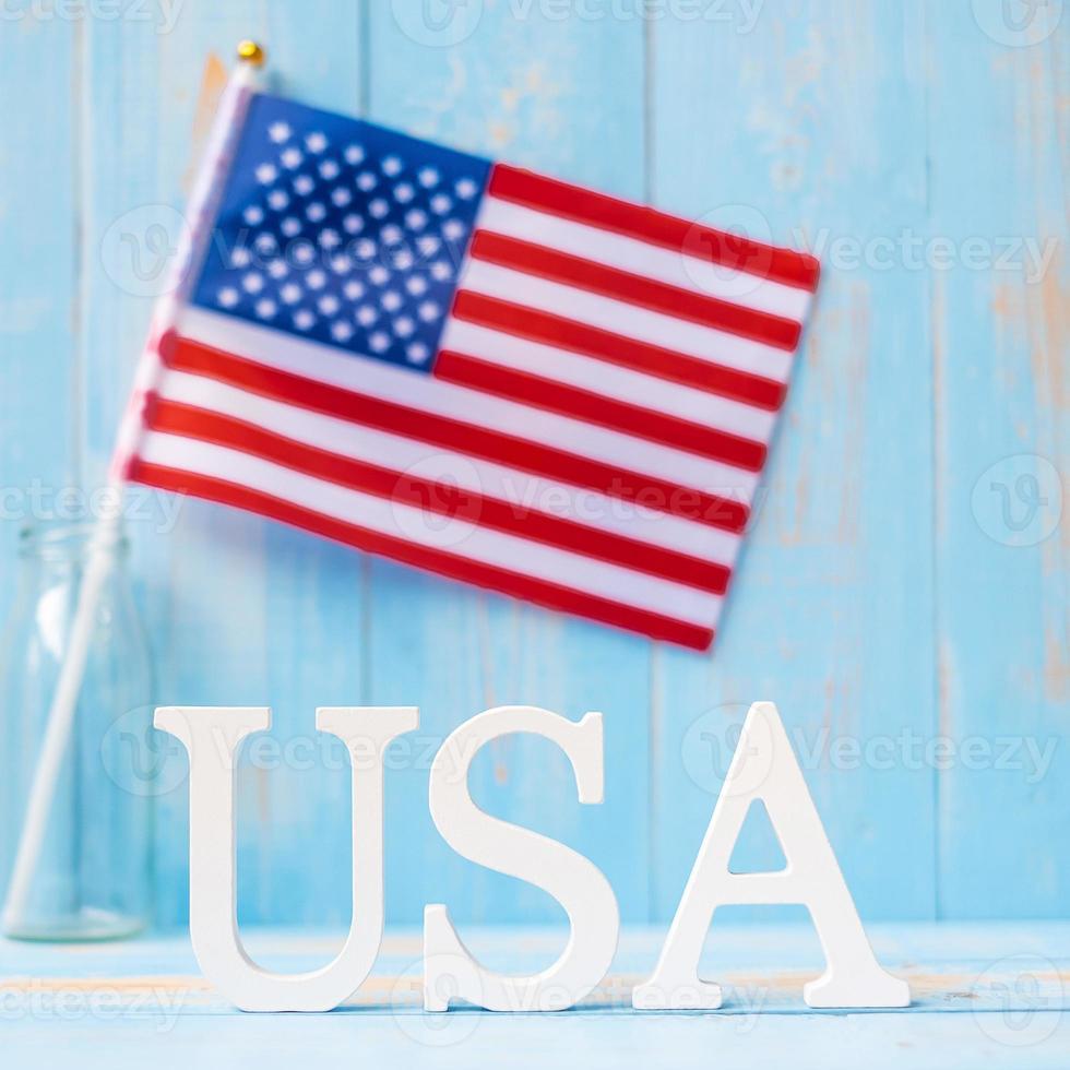 USA text and United States of America flag on wooden table background. concept of Veterans, Memorial, Independence and Labor Day photo