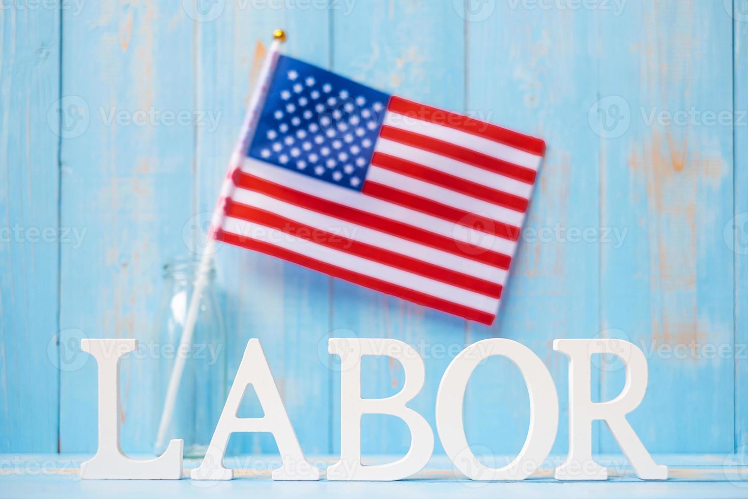 LABOR text and United States of America flag on wooden table background. happy Labor day and holiday celebration concepts photo