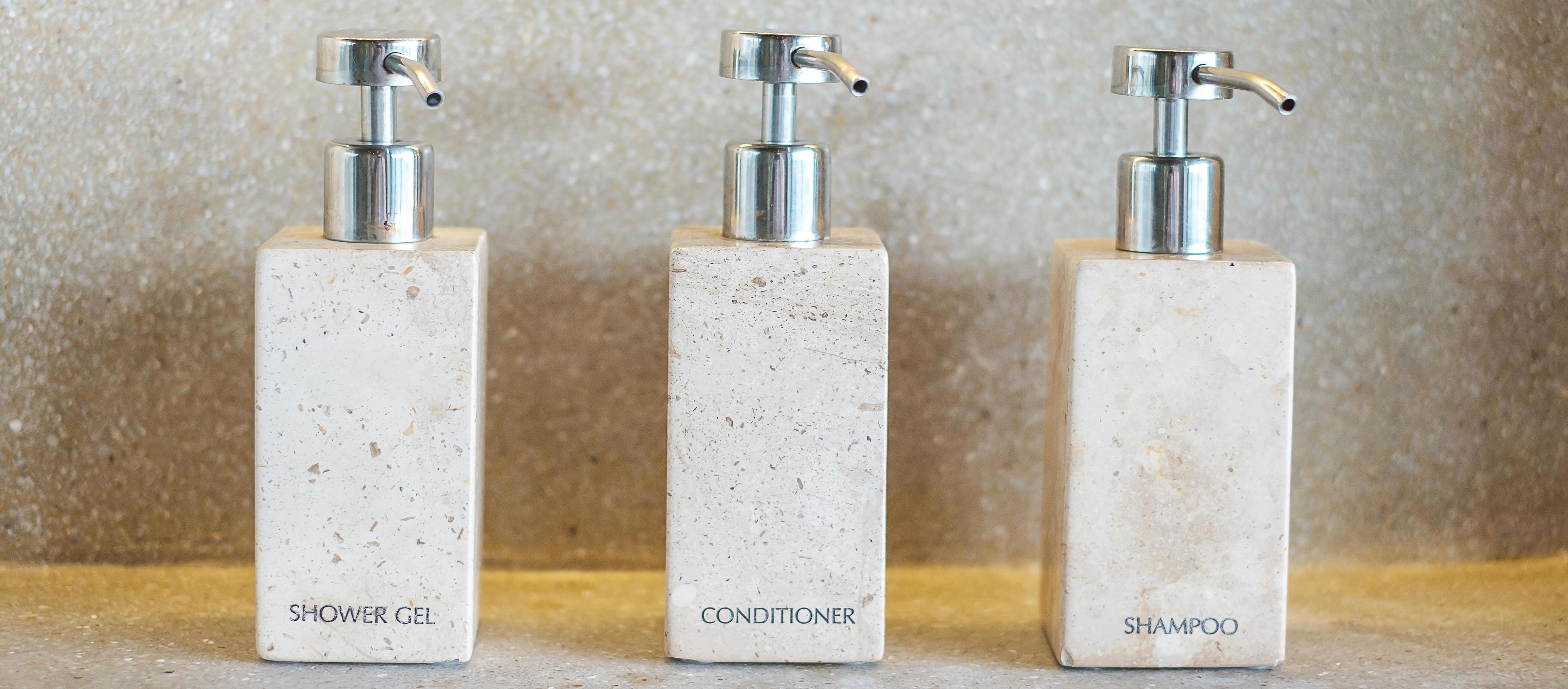 Toiletries bottles in bathroom at luxury hotel or modern home. shower