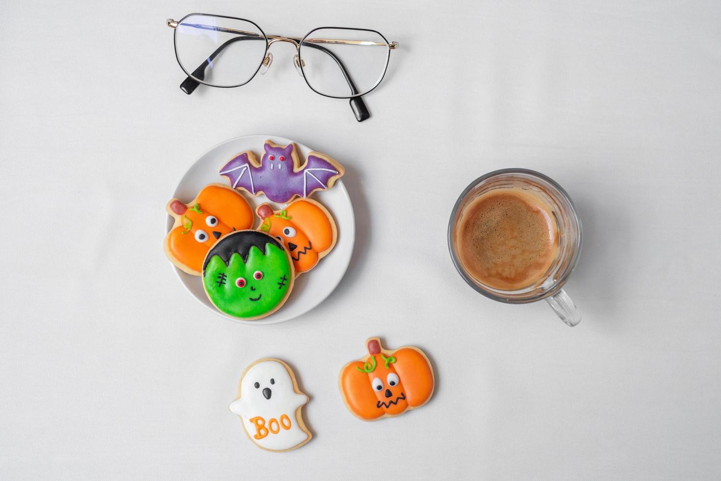 hot espresso coffee  or chocolate cup with funny Halloween Cookies. Happy Halloween day, Trick or Threat, Hello October, fall autumn, Traditional, party and holiday concept photo