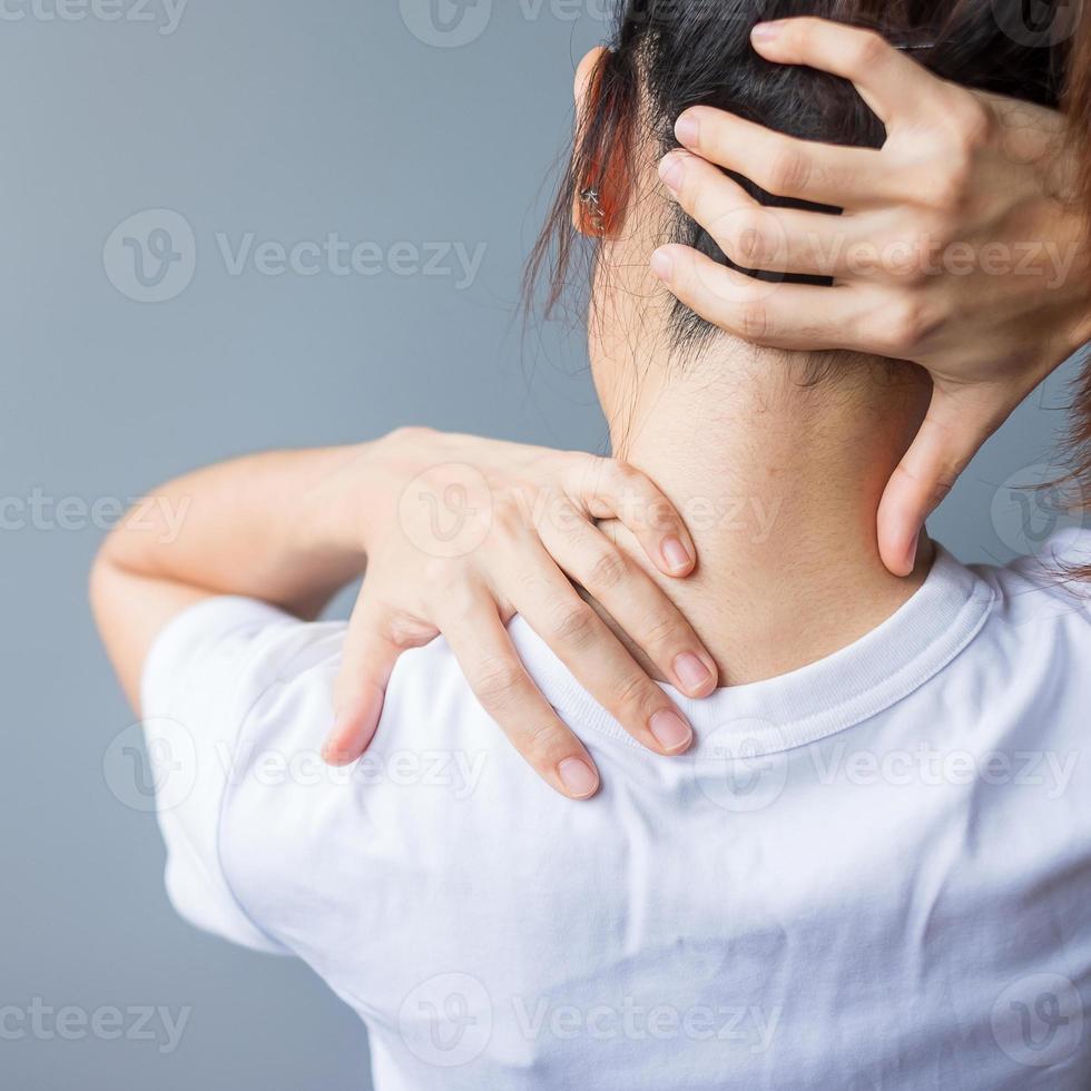 woman with her neck sprain, muscle painful during overwork. Girl having body problem after wake up. Stiff neck, office syndrome and ergonomic concept photo