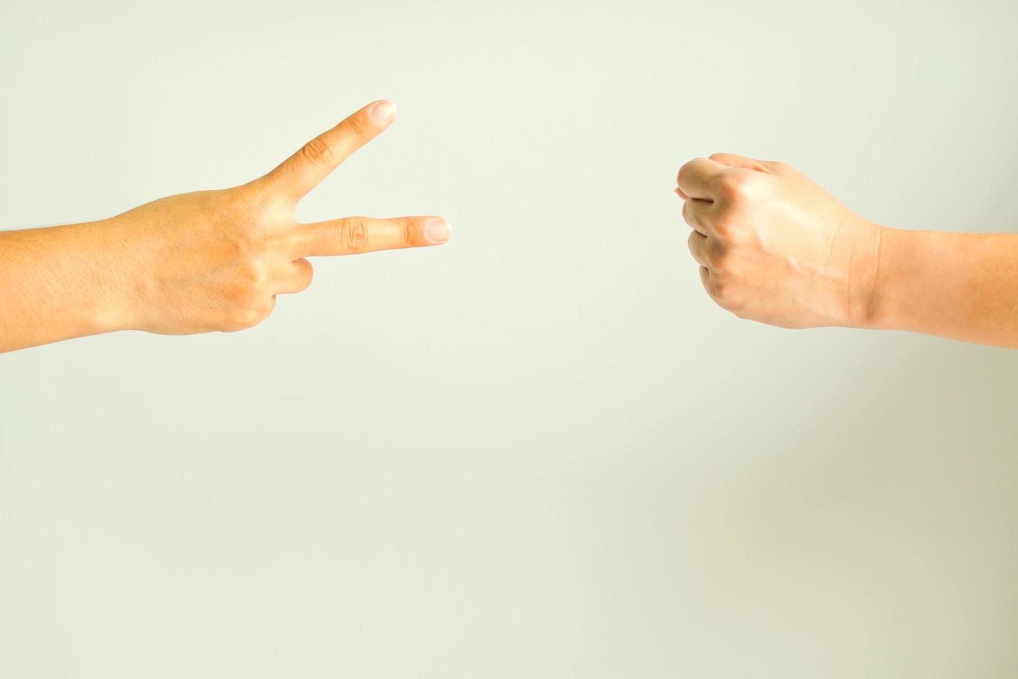 Two person playing rock paper scissors. photo